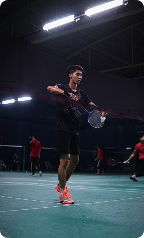 man serving with badminton racket
